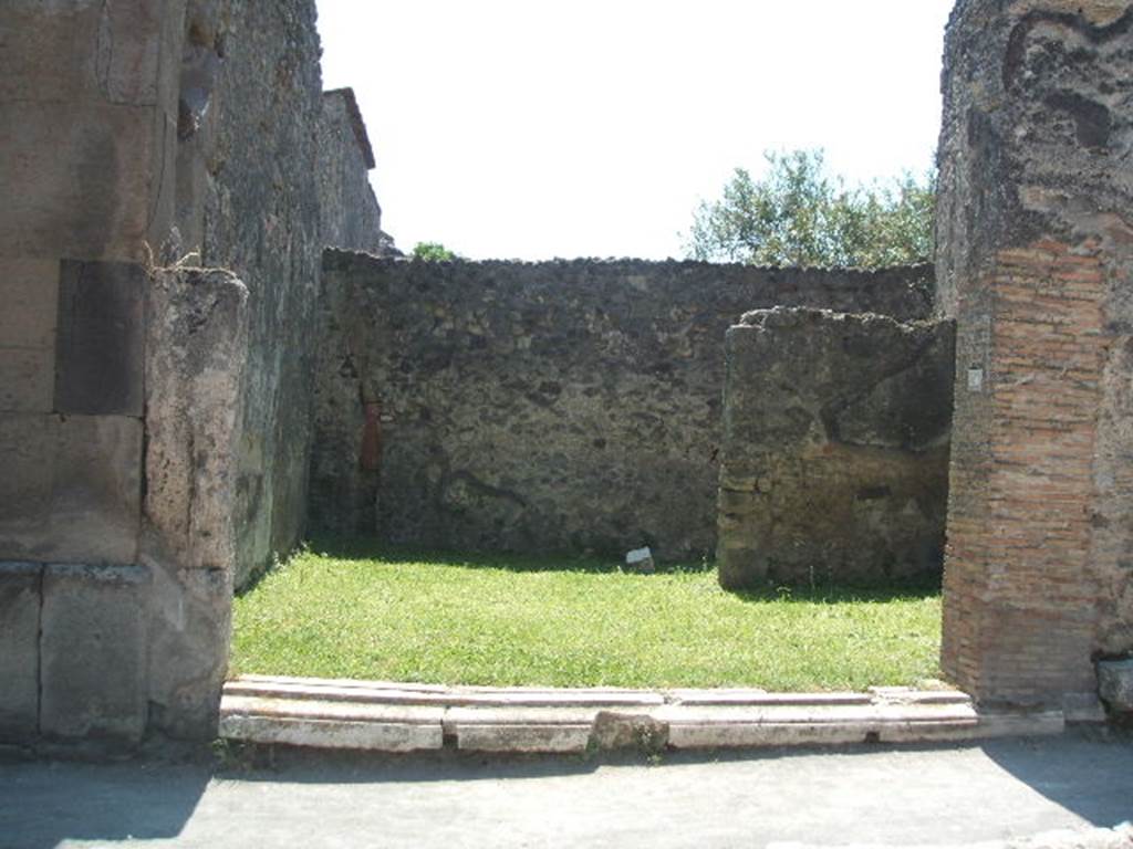 VII.4.50 Pompeii. May 2005. Looking south from entrance, across shop.
According to Fiorelli, this shop had a staircase, a latrine and a rear room.
See Pappalardo, U., 2001. La Descrizione di Pompei per Giuseppe Fiorelli (1875). Napoli: Massa Editore. (p.92).  According to Eschebach, the stairs to the upper floor were on the right, the rear room was in the south-west corner, on the right at the rear. The downpipe from the latrine on the upper floor was in the south-east corner, on the left at the rear. See Eschebach, L., 1993. Geb�udeverzeichnis und Stadtplan der antiken Stadt Pompeji. K�ln: B�hlau. (p.279)


