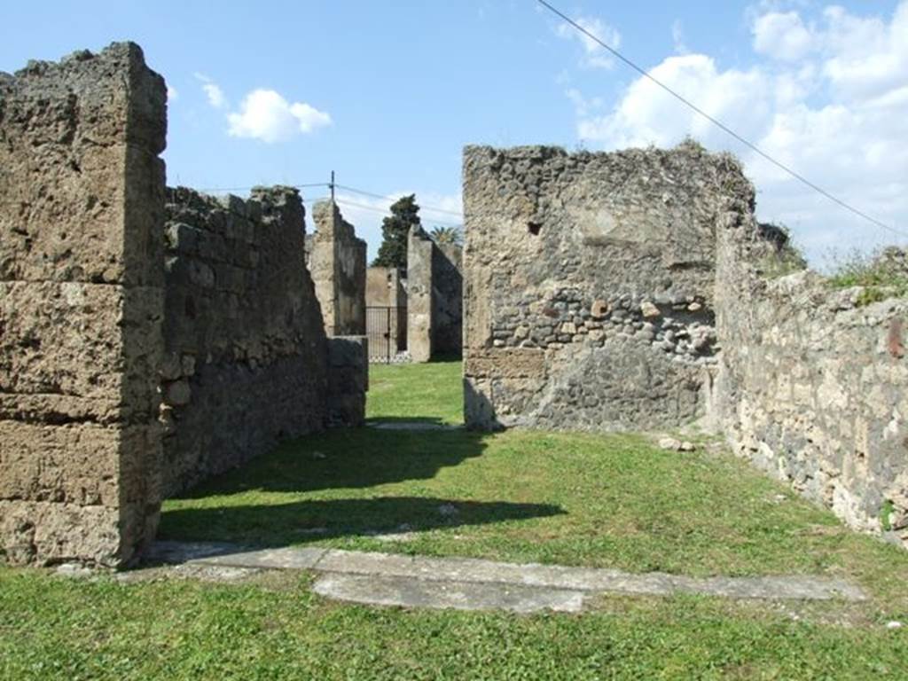 VII.4.57. Pompeii. March 2009. Room 15. Exedra. Looking north to small door in rear wall connecting with Room 1. Atrium.