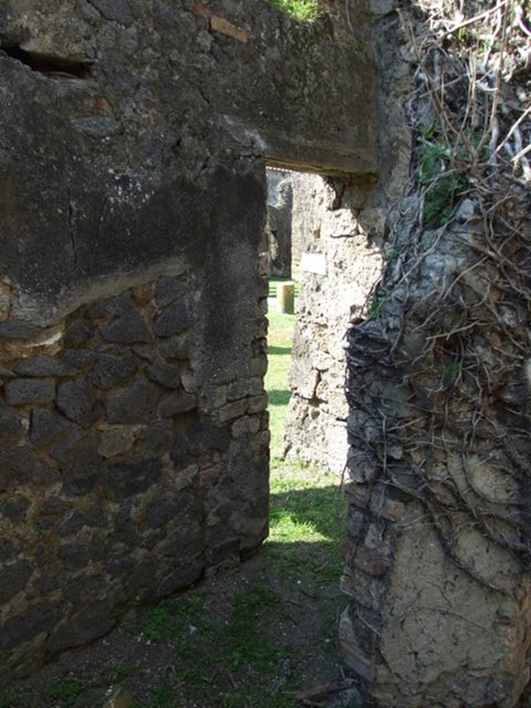 VII.4.57. Pompeii. March 2009. Room 16. Door in north wall, leading to corridor and doorway into East Portico.