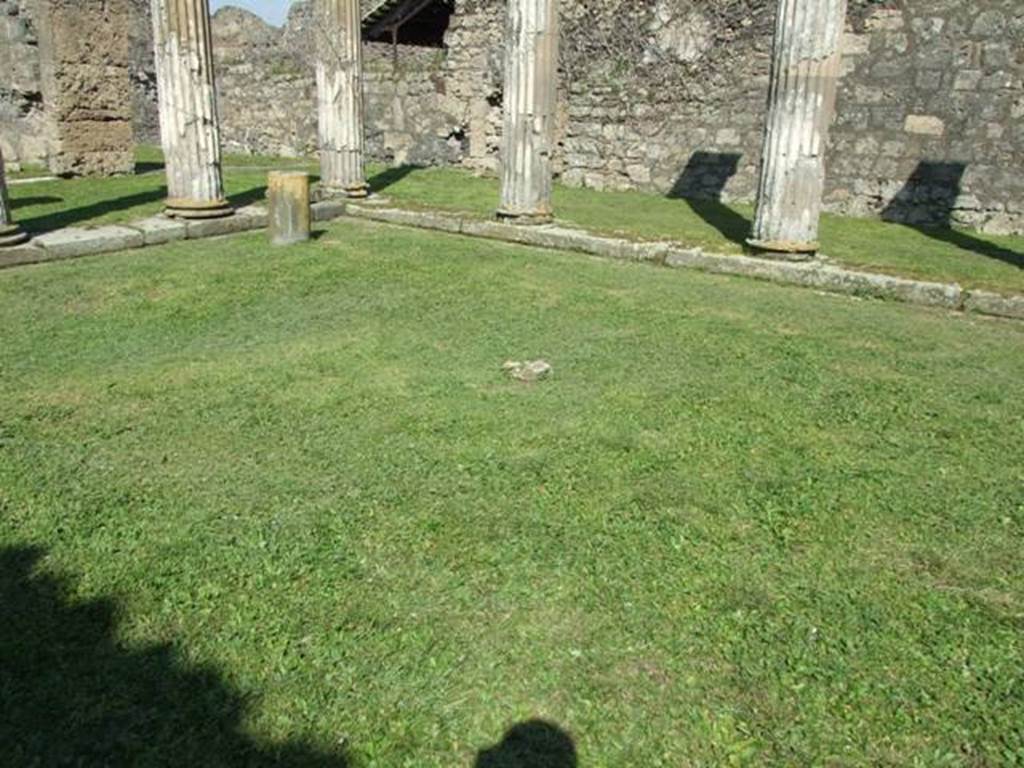 VII.4.57. Pompeii. March 2009. Peristyle. Looking north east towards sundial. The remains of one small masonry column are all that is left of six that used to support a pergola in the centre of the Peristyle.