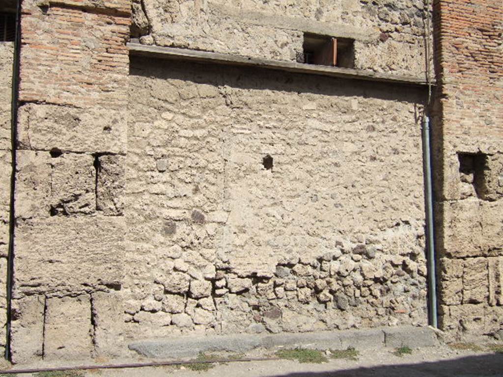 VII.5.15 Pompeii. September 2005. Looking north towards site of doorway to shop.According to Garcia y Garcia, all of the south-west corner and southern part of the insula were transformed in the time of Maiuri.Then the area was hit during the first bombing incursion during the early evening (17.00hrs) of 13th September 1943. All of the old structures that remained have been modified again to provide a restaurant, toilets and sales area. The modifications included closing and bricking up of the old doorways to VII.5.14, 15, 16 and 17. Entrances at VII.5.18, 19 and 20 now provide the doorways to the modern restaurant.  See Garcia y Garcia, L., 2006. Danni di guerra a Pompei. Rome: L�Erma di Bretschneider. (p.101-3).

On the pilaster between VII.5.14 and VII.5.15, on the left, a painting of two gladiators was found in April 1817. Remaining on the pilaster, it gradually faded. Fiorelli said it was almost vanished when he saw it.  
See Jacobelli, L., 2003. Gladiators at Pompeii. Rome: L�Erma di Bretschneider. (p. 79) See Helbig, W., 1868. Wandgem�lde der vom Vesuv versch�tteten St�dte Campaniens. Leipzig: Breitkopf und H�rtel. (1513)

Below the painting of the gladiators were inscriptions painted in red, found 12th April 1818 �
Tetraites  Prudes  Prudes  l(udes)  XIIX  Tetraites  l(udes)  X[�]
abiat  Venere  <P=B>ompei{i}ana( !)  iratum  qui  hoc  laesaerit     [CIL IV 538]
Marcellum  aed(ilem)  EAMH()  roga(t)     [CIL IV 539]
See Pagano, M. and Prisciandaro, R., 2006. Studio sulle provenienze degli oggetti rinvenuti negli scavi borbonici del regno di Napoli.  Naples : Nicola Longobardi.  (p.116)

According to Boyce, in the main room was a lararium painting on a white background. Either side of an altar stood the Genius and the tibicen, both of the same size, behind the Genius was a large cock. On each side of this group stood a Lar of larger stature than the Genius, wearing green and yellow tunics with red pallium. In the zone below were two serpents moving towards an altar furnished with offerings.
See Boyce G. K., 1937. Corpus of the Lararia of Pompeii. Rome: MAAR 14. (p. 67, no.285). 

According to Fiorelli, this was a shop with two rooms, in the first room was the Lararium, in the second room was a vast latrine.
See Pappalardo, U., 2001. La Descrizione di Pompei per Giuseppe Fiorelli (1875). Napoli: Massa Editore. (p.96)




