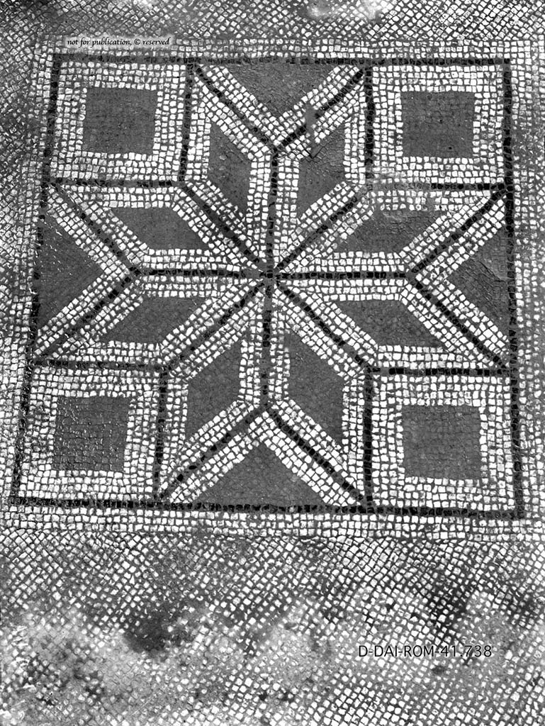VII.6.7 Pompeii.
Room 52, mosaic floor with white background, in the middle was a square showing a star resulting from eight white diamonds with black band around, each comprising a smaller, red diamond.
DAIR 41.738. Photo © Deutsches Archäologisches Institut, Abteilung Rom, Arkiv.
See Pernice, E. 1938. Pavimente und Figürliche Mosaiken: Die Hellenistische Kunst in Pompeji, Band VI. Berlin: de Gruyter, (p.89-90, and taf. 41,4 above).
According to PPM –
“The floors were for the most part in cocciopesto, lavapesta intermingled with brick, or white mosaic with emblemata already removed during the explorations of the Bourbon age (cf. PAH 1,2, p.144, 10 April 1762) and today no longer found, although documented by Pernice.
Among the lost motifs are the hexagon with prospective cube of tiles in the cubiculum (40), or the 8-pointed star resulting from the combination of its many diamond-shapes inserted into a square in the cubiculum (52), a room also known for the lowered vaulted cover on the alcove and flat ceiling on the rest of the room, or finally the kantharos outlined in black, red, yellow and white tesserae, placed in the threshold of the triclinium and destroyed by the roots of spontaneous vegetation in the winter of 1928.”
( I pavimenti erano per lo piu in cocciopesto, lavapesta con frammisti laterizi che ne ravvivavano il colore o a mosaico bianco con emblemata gia asportati durante l’esplorazione di eta borbonica (cfr, PAH 1,2, p.144, 10 aprile 1762) e oggi non piu riscontrabili, anche se documentati da Pernice.
Tra i motivi perduti ricordiamo l’esagono con cubo prospettico di piastrelle nel cubicolo (40), o la stella a 8 punte risultante dalla combinazione di altrettanti rombi inserita in un quadrato nel cubicolo (52), ambiente notevole anche per la copertura a volta ribassata sul’alcova e piana sulla restante parte della stanza, o, infine, il kantharos delineato in tessere nere, rosse, gialle e bianche, posto nella soglia del triclinio e distrutto dalle radici della vegetazione spontanea nell’inverno del 1928.
See PPM, VII, 7, (p.176)