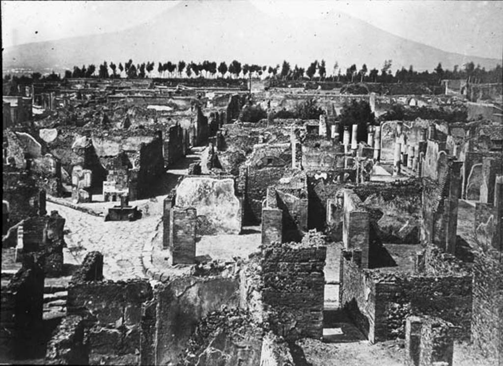 VII.6.7 Pompeii. Looking north across north side of insula VII.6, lower photo, across to Via Consolare and junction with Vicolo di Modesto, centre left, and VI.6, centre right. The entrance doorway of VII.6.7 would have been the one on the left of the photo. Photo by permission of the Institute of Archaeology, University of Oxford. File name instarchbx208im011. Source ID. 44337.
