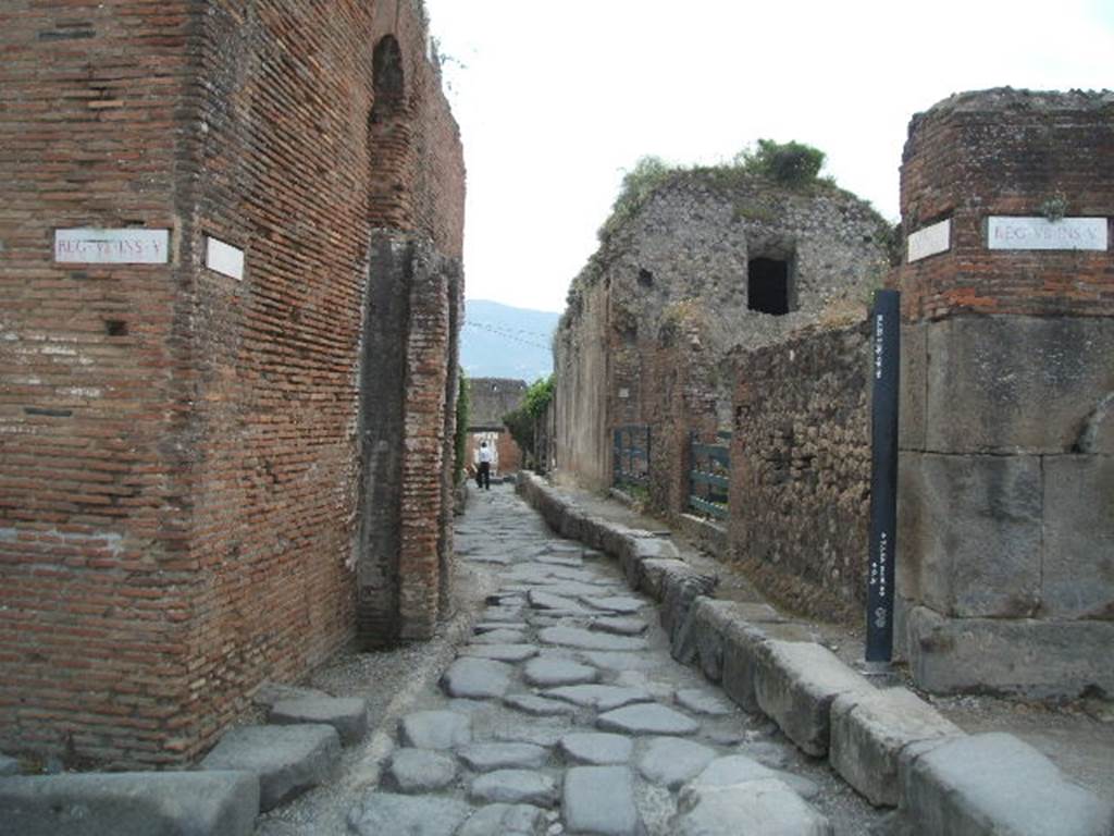 VII.5 Pompeii. May 2005. Vicolo delle Terme looking south. The reservoirs at VII.6.17 are the tall buildings on the right. The water tower at the Forum Baths is on the left.
According to Clarke � 
�The Piscina or reservoir is separated form the baths themselves by the street, which opens onto the Forum. The pipes which communicated between the reservoir and the bath passed over an arch thrown across the street. This arch was perfect when the excavation was made; now only the shoulders remain, in which the pipes above-mentioned are still visible.� 
See Clarke, W. (1833). Clarke�s Pompeii. Boston, USA, Lilly, Wait, Colman and Holden, (p. 158).

