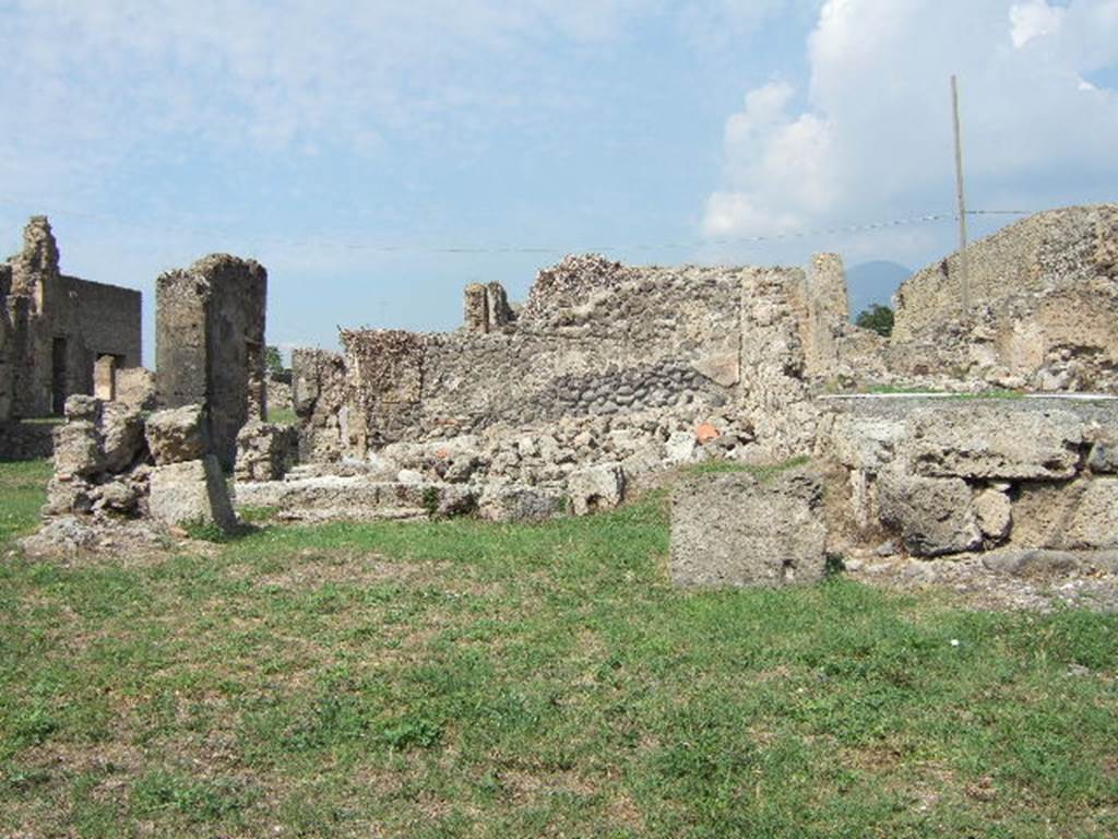 VII.6.27 in lower right-side corner, with VII.6.28 on left and in background. September 2005. According to Fiorelli and Eschebach, this shop had a staircase to the upper floor against the west wall, a doorway linking to VII.6.26 in the east wall, and a rear room. See Pappalardo, U., 2001. La Descrizione di Pompei per Giuseppe Fiorelli (1875). Napoli: Massa Editore. (p.160)  See Eschebach, L., 1993. Geb�udeverzeichnis und Stadtplan der antiken Stadt Pompeji. K�ln: B�hlau. (p.296)
