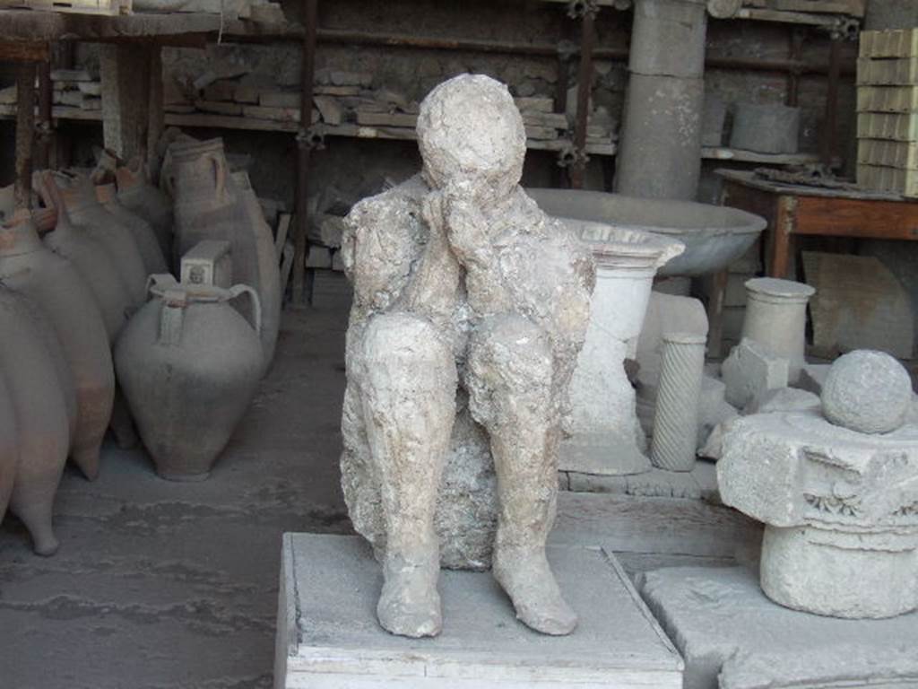 VII.7.29 Pompeii. May 2006. Plaster cast of body and items in storage.