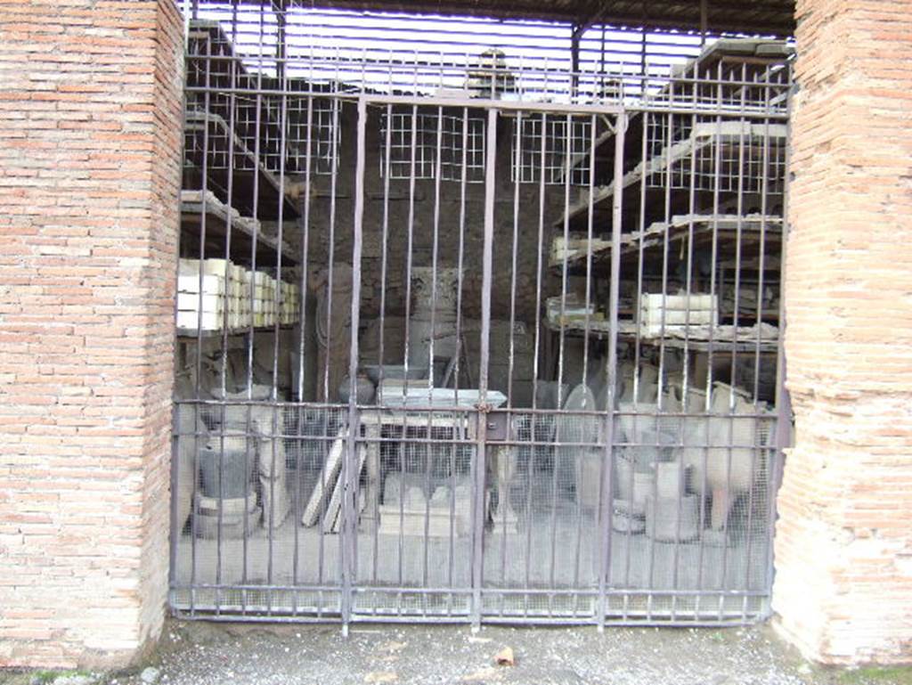VII.7.29 Pompeii. May 2006. Looking west through entrance doorway towards items in storage.