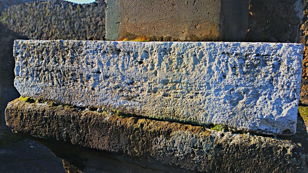 VII.7.32 Pompeii. December 2019.
Looking south-west to inscribed stone at base of statue of Artemis. Photo courtesy of Giuseppe Ciaramella.