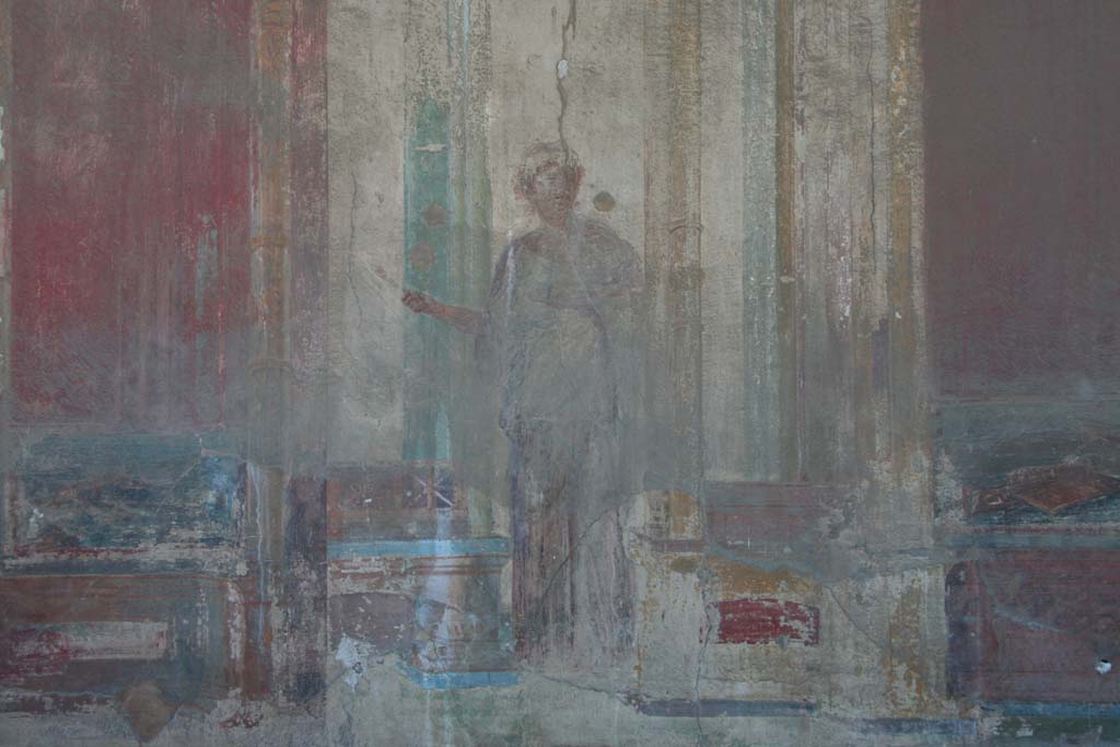 VII.9.7 and VII.9.8 Pompeii. Macellum. April 2013.
North-west corner. Detail of architectural painting with female figure, from west wall.