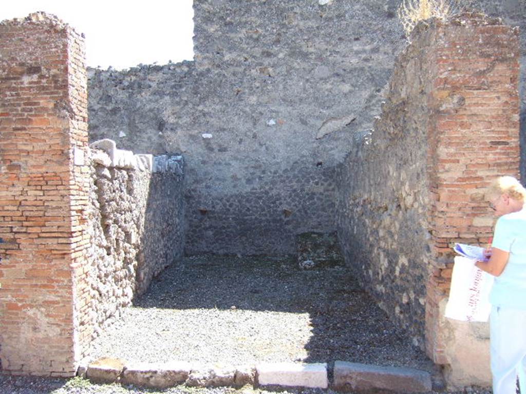 VII.9.16 Pompeii. September 2005. Looking south across entrance doorway. In the south-west corner, on the right at the rear, can be seen the base of steps to upper floor.
