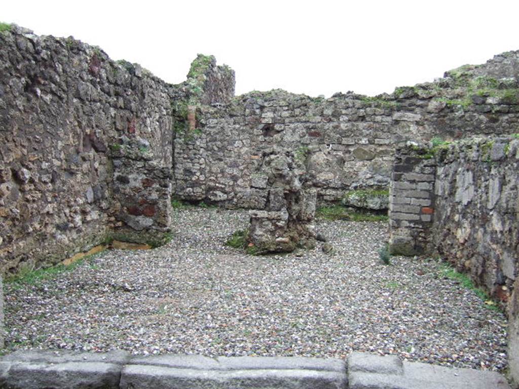 VII.9.50 Pompeii.  December 2005. Looking south across shop, to two rear rooms. According to Fiorelli, the shop had a counter with a simple hearth and at the rear were two rooms, one with the usual staircase.  See Pappalardo, U., 2001. La Descrizione di Pompei per Giuseppe Fiorelli (1875). Napoli: Massa Editore.(p107)  According to Liselotte Eschebach, to the left was a rear room with a hearth, and a downpipe from latrine on upper floor. To the right was another room with a staircase to the upper floor.  See Eschebach, L., 1993. Geb�udeverzeichnis und Stadtplan der antiken Stadt Pompeji. K�ln: B�hlau. (p317)
