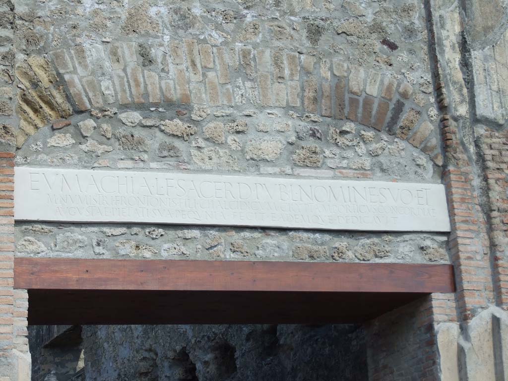 VII.9.67 Pompeii. March 2009. Copy of marble plaque with inscription, re-instated above the doorway.