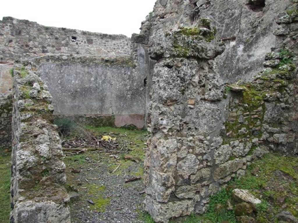 VII.10.12 Pompeii. March 2009. Doorway to triclinium in south-east corner of atrium. 
According to Boyce, on the east wall of the atrium entered at number 12 was a lararium painting on a white background.
The Genius, wreathed and wearing a toga with a fold drawn over his head, held a cornucopia in his left hand.
With his right hand, he poured a libation from a patera onto a blazing altar around which a serpent was coiled.
His head was excellently preserved and exhibited the features of the Roman portrait type of the early Empire.
In the wall above the painting was a niche.
See Helbig, W., 1868. Wandgem�lde der vom Vesuv versch�tteten St�dte Campaniens. Leipzig: Breitkopf und H�rtel, (31).
See Fiorelli, G., 1875. Descrizione di Pompei. Napoli, p. 276.
See Boyce G. K., 1937. Corpus of the Lararia of Pompeii. Rome: MAAR 14. (p.69, no.309, numbered as VII.x.9-12).
