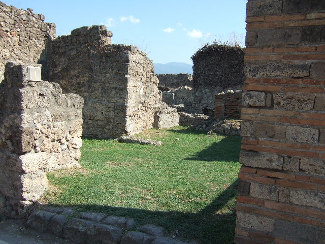 VII.12.1 Pompeii. May 2010. Looking south to room with oven and entrance VII.12.37, on the right.