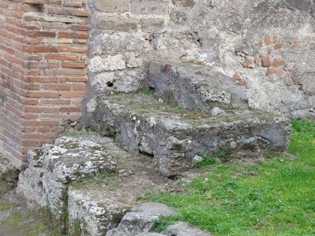 Outside VII.12.4 Pompeii.  December 2007.  Via degli Augustali looking east, with grooves worn by traffic.