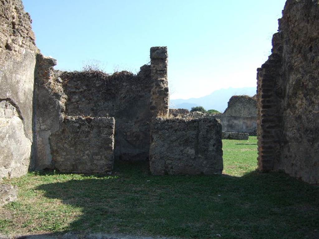 VII.12.4 Pompeii. September 2005. South wall with small rear room and doorway to atrium of VII.12.3.
