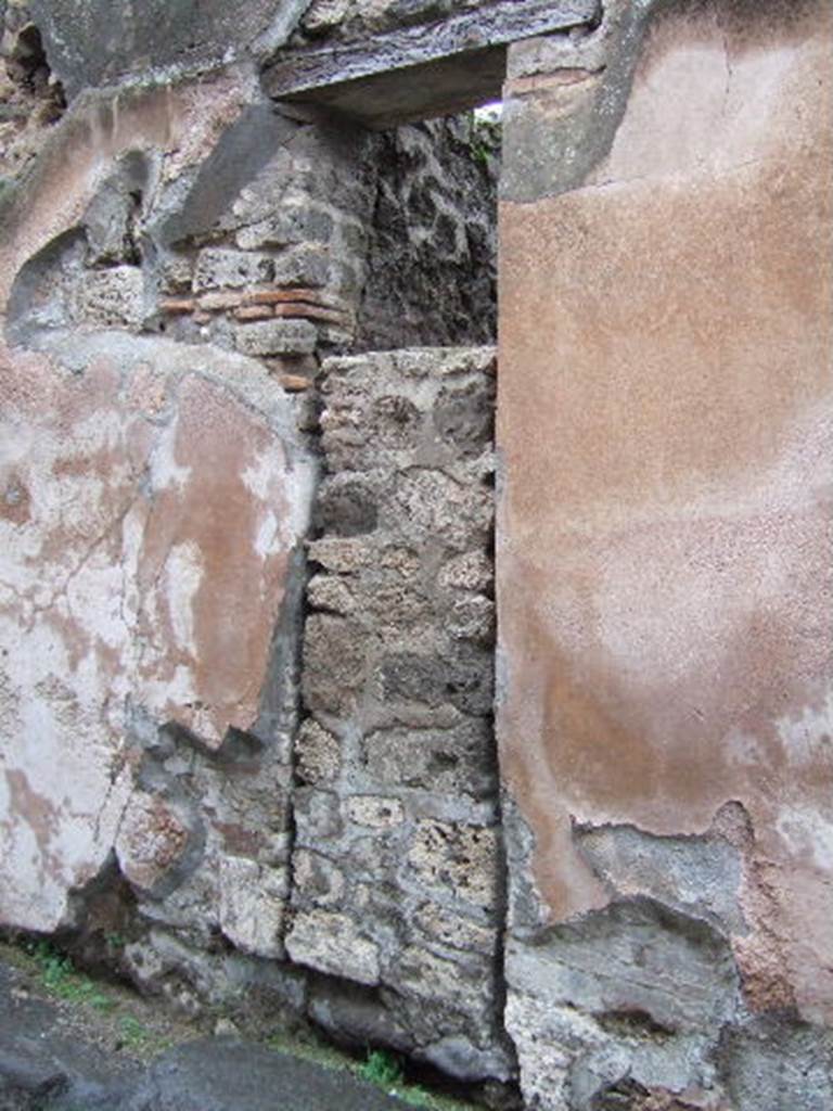 VII.12.22 Pompeii. December 2007. Entrance doorway to workshop with steps to upper floor showing plaster to right of entrance.