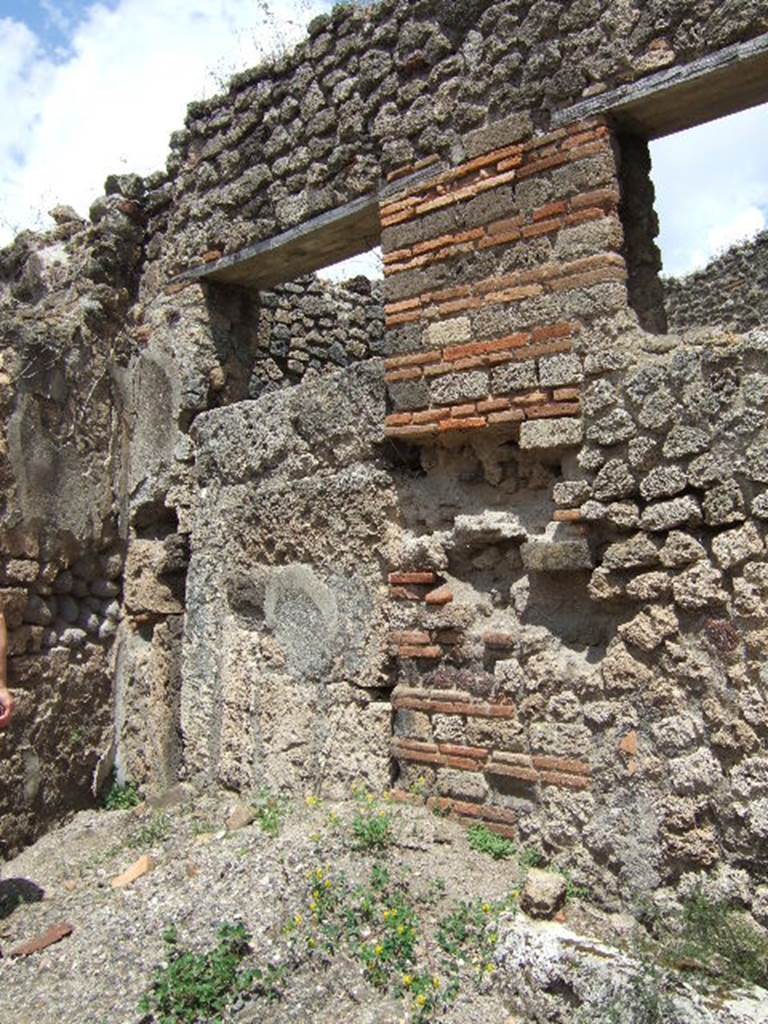 VII.12.25 Pompeii, at front, door to VII.12.26 centre and blocked door at VII.12.24 on right. December 2005.
