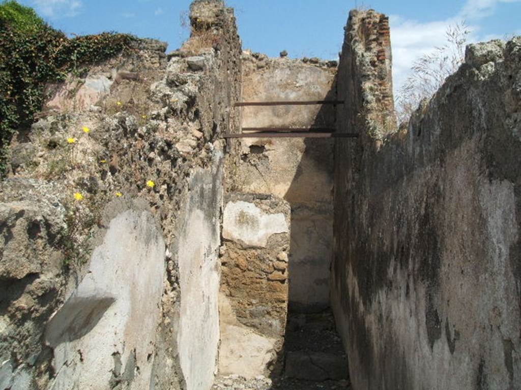 VII.14.4 Pompeii. May 2010. South wall of rear room, with doorway on south-east side.