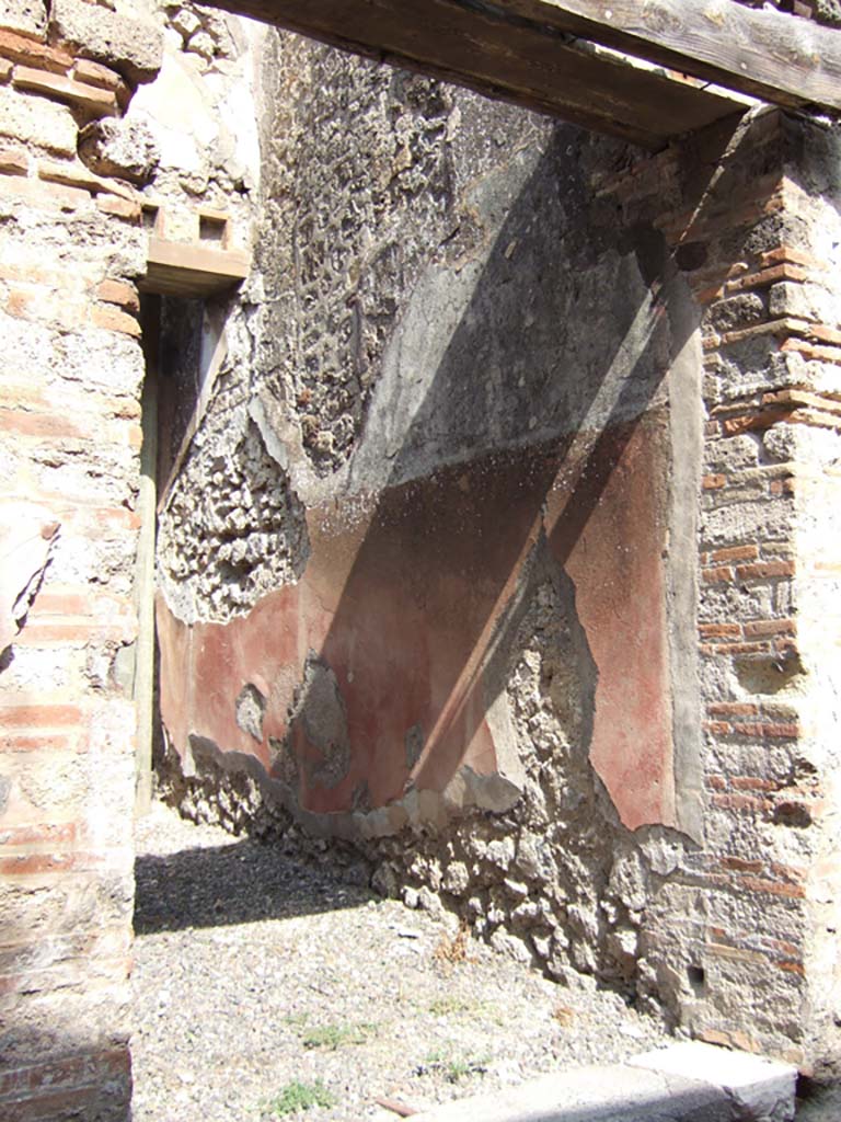 VII.15.5 Pompeii. September 2005. Niches.Boyce recorded a rectangular niche with a red panel on each side. Each panel was painted with a yellow and black serpent coiling upwards with the head at the top.
See Boyce G. K., 1937. Corpus of the Lararia of Pompeii. Rome: MAAR 14.  (p. 72, no.330, plate 12,3).
