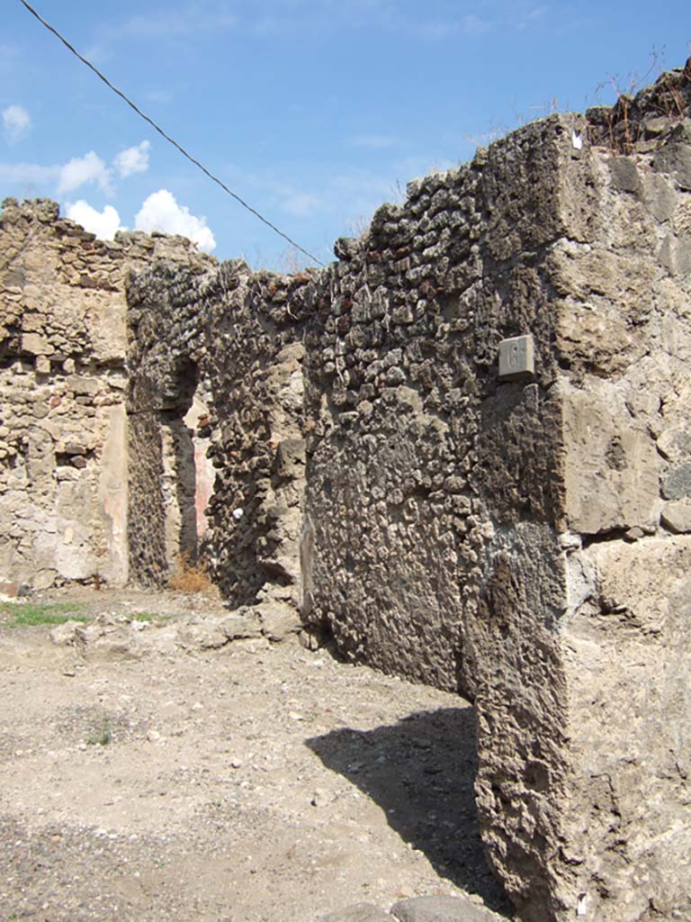 VII.15.6 Pompeii. December 2007. Looking north across shop-room towards rear rooms. On the left would have been the steps to upper floor, on the right a rear room with window to VII.15.7.
