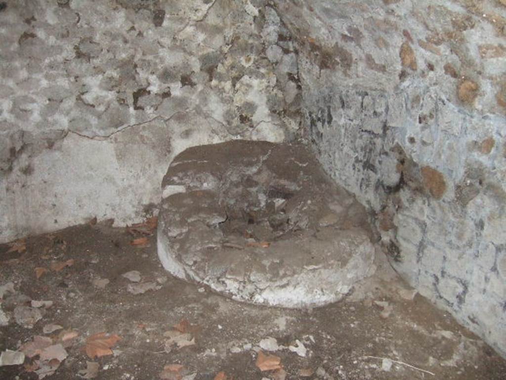 VII.15.16 Pompeii. May 2006. Open space (I), south-east corner with circular masonry base.   
According to Franklin, in the centre of the masonry base was a small basin.   
See Franklin, J.L. (Jnr) 1990. Pompeii, the Casa del Marinaio and its history. SAP, monograph 3. Roma; L�ERMA di Bretschnieder, (p.36).
