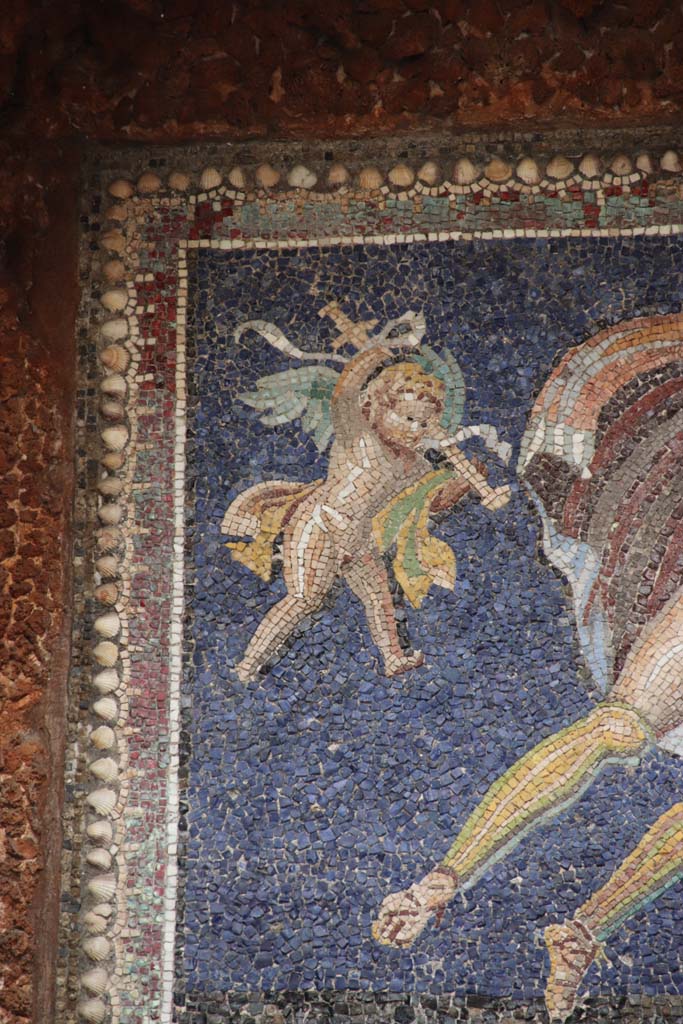 VII.16.a Pompeii. September 2021.
Room 9, nymphaeum, detail of mosaic cherub. Photo courtesy of Klaus Heese.