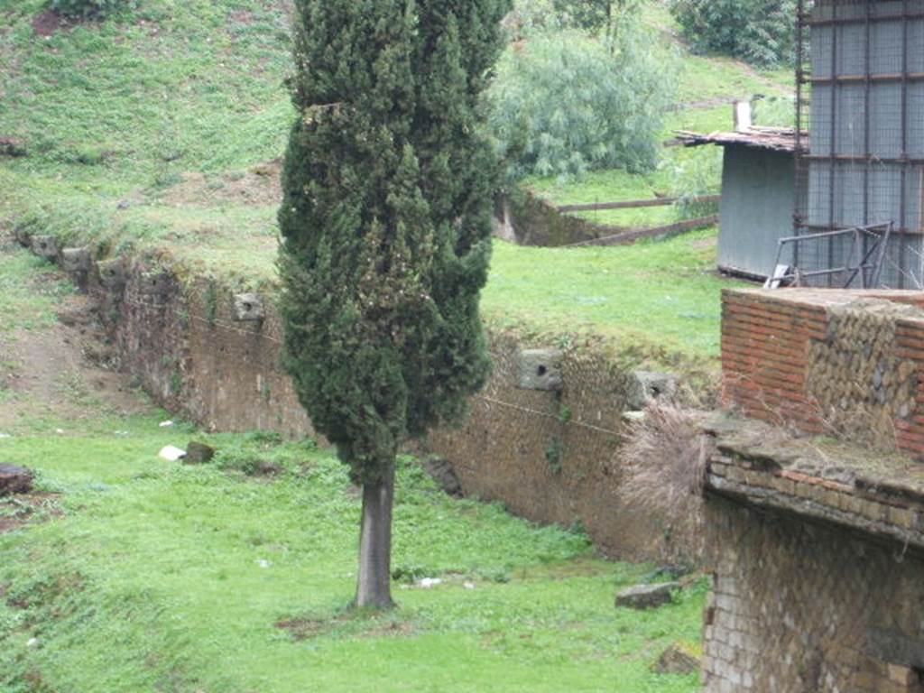 VII.16.a Pompeii. December 2004. Mooring rings? Located in wall on north side. According to Descoeudres, for many years this area had been described as the quay wall of the harbour.
The idea of a sea-wall is likely to go back to the 1950�s, when it was discovered during clearing work under Maiuri�s direction. If this were indeed the walls of the Pompeii harbour then it would have been ten metres above sea-level. A trial trench excavated in June 1998 proved this idea to be false. The reason for the rings, very similar to ancient mooring rings, must remain unknown. See Rivista di Studi Pompeiani, 1998, IX, article by Descoeudres, J.P: The so-called quay wall north-west of Pompeii�s Porta Marina. (p.210-217)


