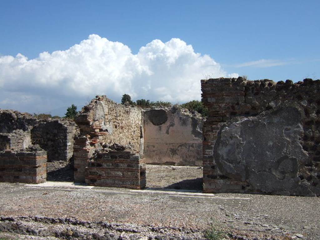 VIII.2.26 Pompeii. September 2005. East side of the atrium, with doorways to services area ‘h’, and cubiculum ‘L’. When excavated the floor of cocciopesto of cubiculum ‘L’ was found to be of excellent quality with a combination of octagons and stars. In the centre of the octagons were white crosses containing black central tesserae.