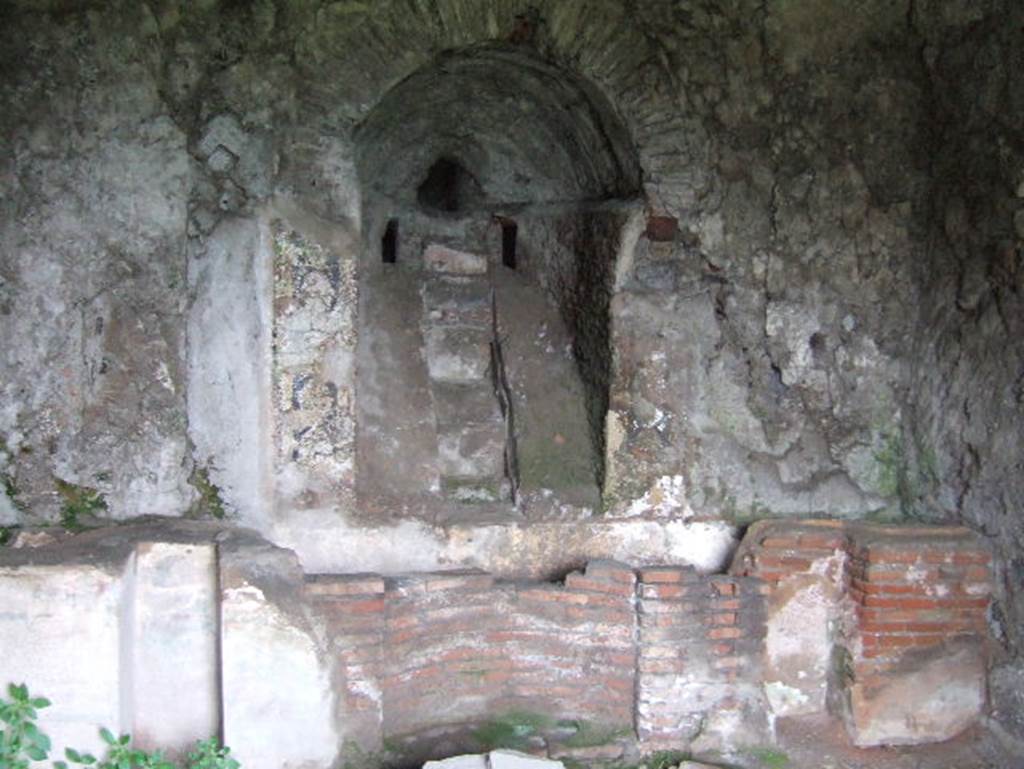 VIII.2.28 Pompeii. May 2006. Nymphaeum. According to Richardson, the water entered by a water stair in a deep vaulted niche and fell into a narrow basin that extended across the width of the room. The front wall of the narrow basin was broken into niches, rather like a theatre stage.
See Richardson, L., 1988. Pompeii: an Architectural History. Baltimore: John Hopkins University Press. (p.231-2).