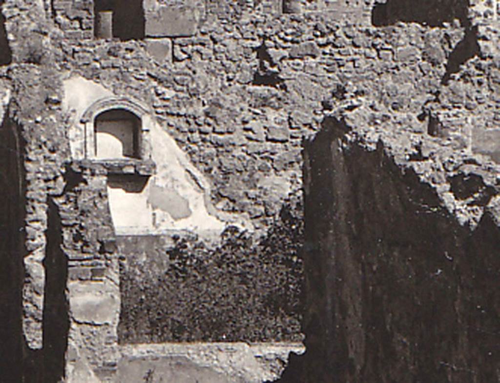 VIII.3.21 Pompeii. Detail of niche and garden from postcard dated 1st August 1939.
According to Boyce, in the north wall of the garden was an arched niche adorned with an aedicula façade.
The façade had a modelled stucco cornice running around the curve of the arch.
It also had a heavy ledge projecting from the wall.
The inside walls of the niche were covered with white stucco and outlined with red stripes.
See Boyce G. K., 1937. Corpus of the Lararia of Pompeii. Rome: MAAR 14. (p.76, no.356, & Pl.3,5 photo by Warscher).
Photo courtesy of Drew Baker