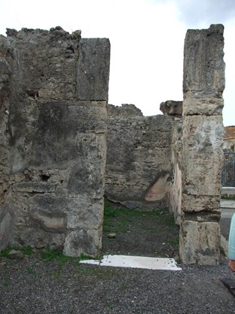 VIII.3.27 Pompeii. December 2007. Cubiculum to south of entrance fauces. Looking through doorway to north-west corner. In this room the floor was of cocciopesto which also had irregularly scattered black and white tesserae. In the west wall it used to be possible to see the slender candelabra design in the south panel of the side panels of the middle zone. In the north wall, the zoccolo was visible as well as the red middle zone but did not retain any details of the decorations.