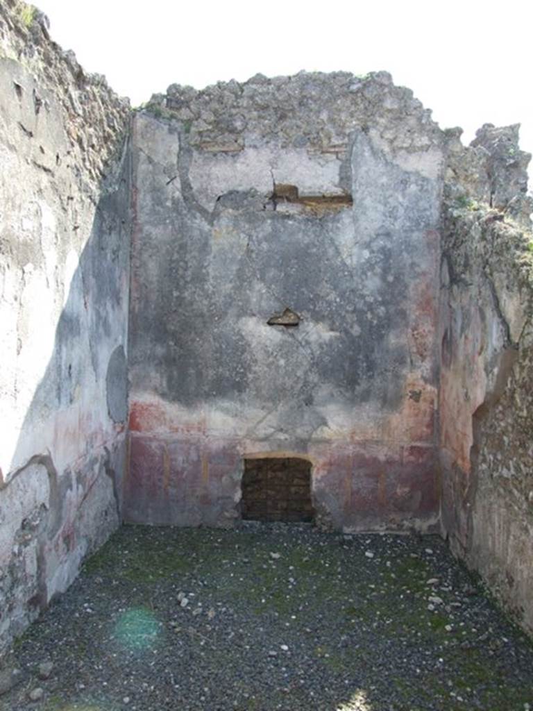 VIII.4.4 Pompeii. March 2009. Room 12, south wall. In the red zoccolo, at the centre was a panel with a border, to the sides were narrow panels with birds and plants. The middle yellow zone contained a painting at the centre showing “the contest of the divinity of the light”. The side panels were red; the upper zone was faded.

