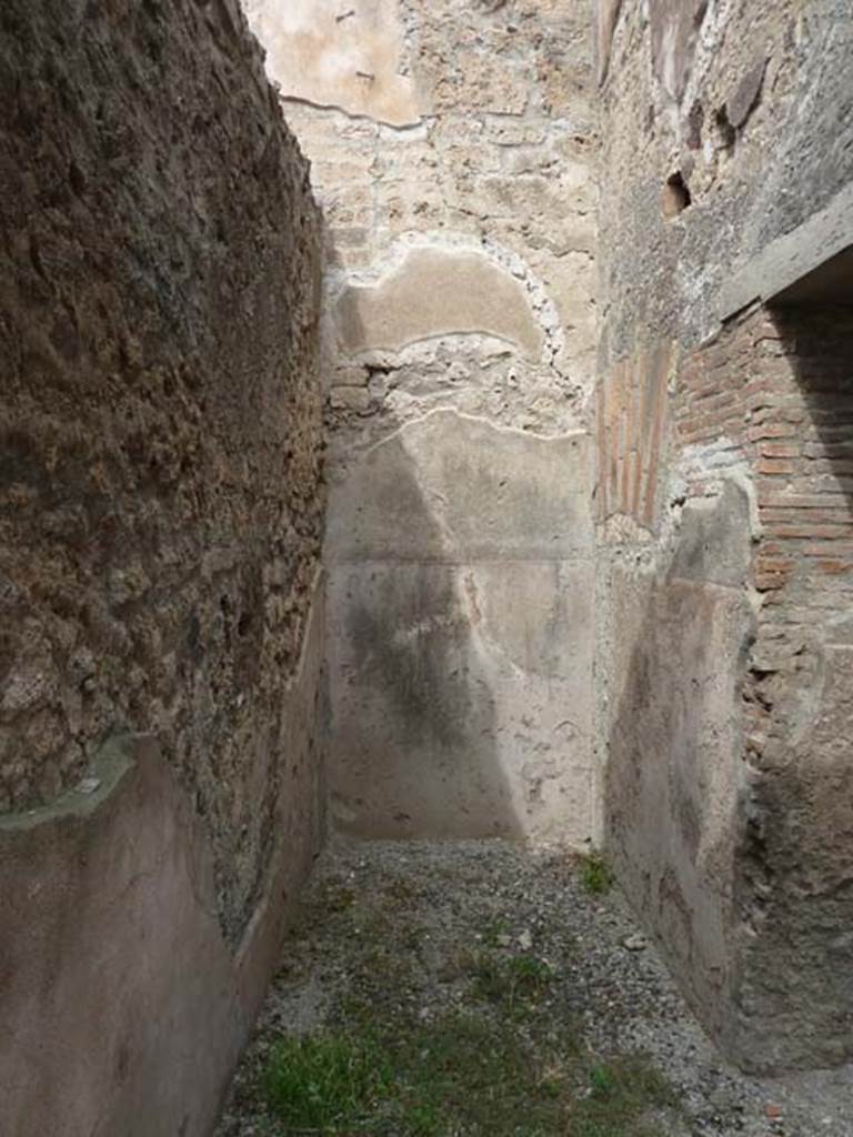 VIII.4.37 Pompeii. September 2015. Looking north into small corridor with area of small room/cupboard with stairs to upper floor. The doorway to the triclinium with window, is on the right.