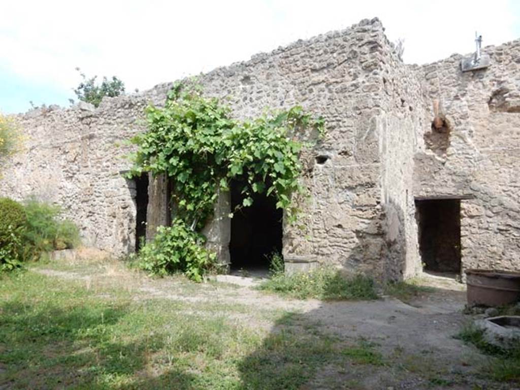 VIII.5.15 Pompeii. May 2017. Room 2, looking towards doorways in north wall.
The small room under the stairs in room 1 can be seen on the right.
Room 8 a cubiculum is the doorway on the left, the doorway into room 9 which was another cubiculum is in the centre.
Photo courtesy of Buzz Ferebee.