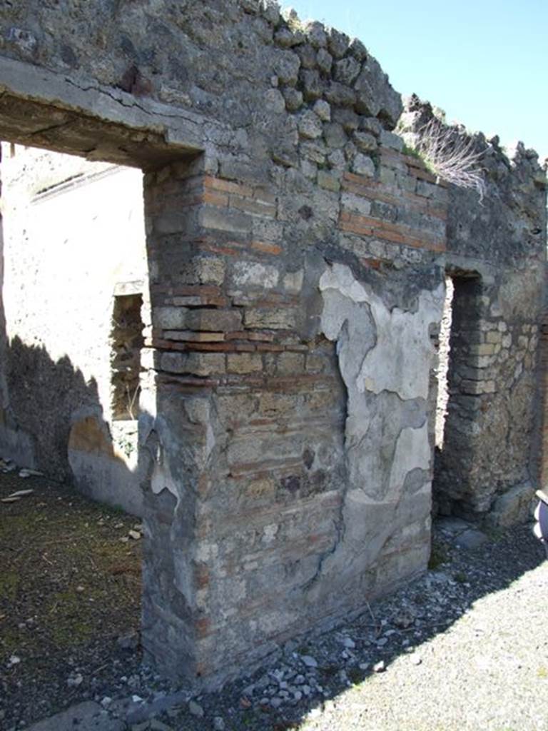 VIII.5.39 Pompeii. March 2009. Wall of Room 1 with remains of plaster, between Rooms 5 and 6.