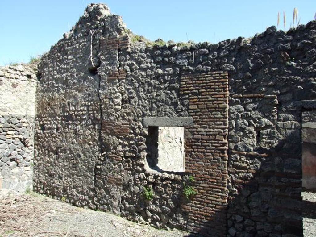 VIII.5.39 Pompeii. March 2009. Room 6, east wall of small garden area, with window to room 7, and doorway.