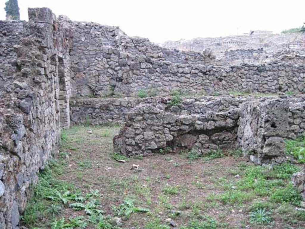 VIII.7.1 Pompeii. September 2010. Photo courtesy of Drew Baker.
Rear of entrance room looking north towards doorway to room, possibly a dormitory. According to Fiorelli, the site of a stable manger was against the wall. The wall was a painted wall giving him the impression that originally the hospitium had seen better days. The doorway to the area used as the stable can be seen on the right. See Pappalardo, U., 2001. La Descrizione di Pompei per Giuseppe Fiorelli (1875). Napoli: Massa Editore. (p.131)