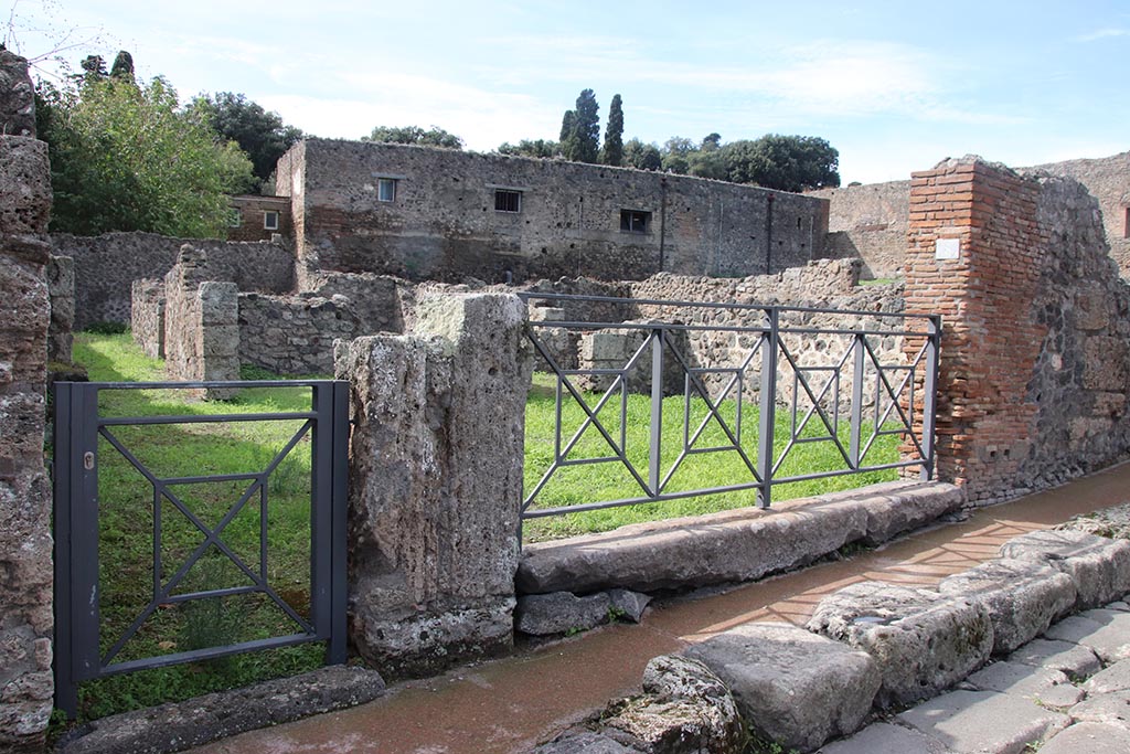 VIII.7.7 Pompeii, on left, and VIII.7.8. October 2024.
Looking north-west to entrance doorways on Via Stabiana. Photo courtesy of Klaus Heese.