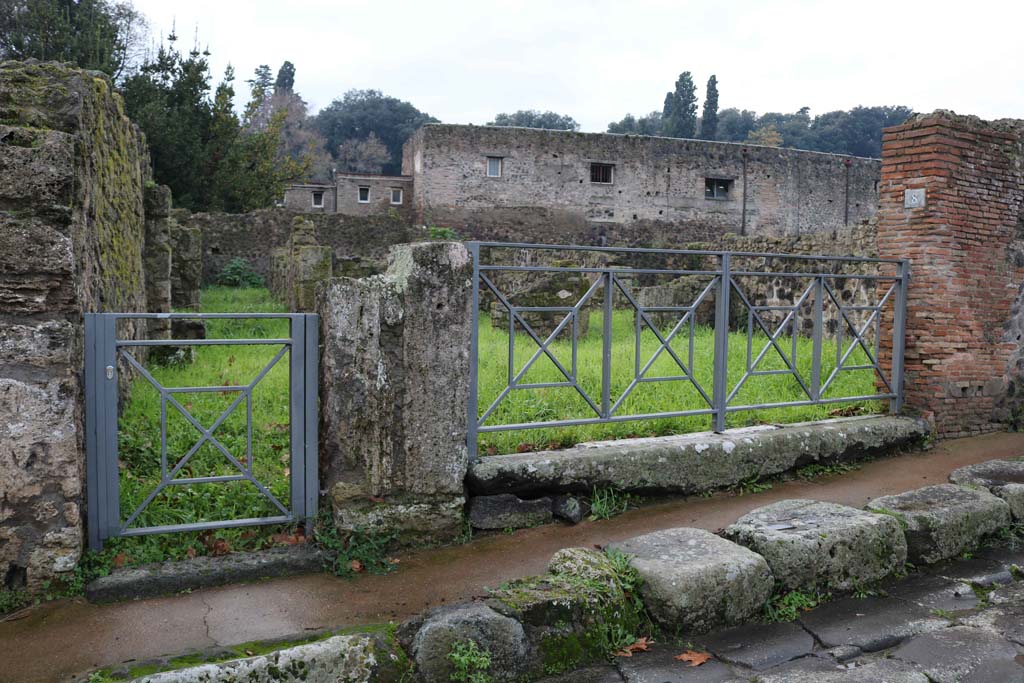 VIII.7.7 Pompeii, on left, and VIII.7.8. December 2018.
Looking west to entrance doorways on Via Stabiana. Photo courtesy of Aude Durand.