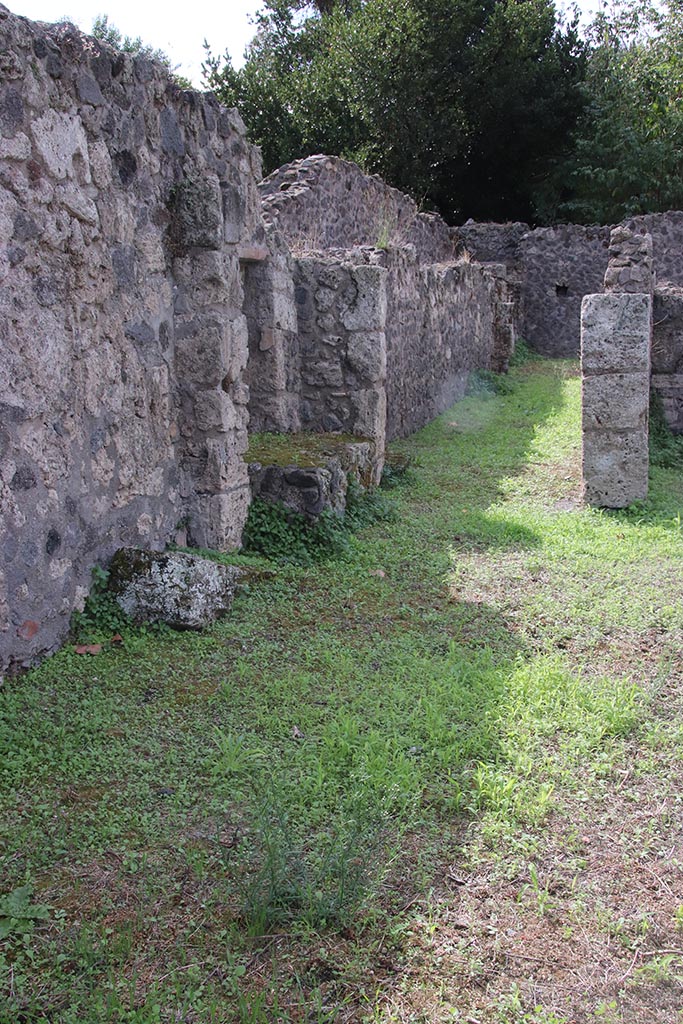 VIII.7.8 Pompeii. October 2024.
Looking west towards corridor along south side of workshop room. Photo courtesy of Klaus Heese.