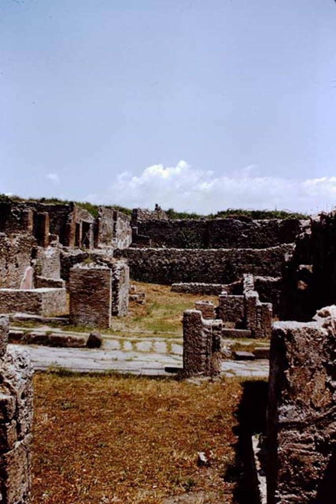 VIII.7.8 Pompeii, on left. 1966. Looking east from rear of VIII.7.8 towards Via Stabiana, with steps to upper floor at VIII.7.7, centre right. On the opposite side of Via Stabiana, I.1.8 can be seen. Photo by Stanley A. Jashemski.
Source: The Wilhelmina and Stanley A. Jashemski archive in the University of Maryland Library, Special Collections (See collection page) and made available under the Creative Commons Attribution-Non Commercial License v.4. See Licence and use details.
J66f0200