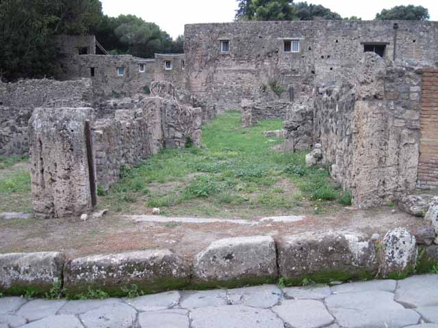 VIII.7.11 Pompeii. September 2010. Looking west across rear room to corridor and doorway to cubiculum (on right). Photo courtesy of Drew Baker.