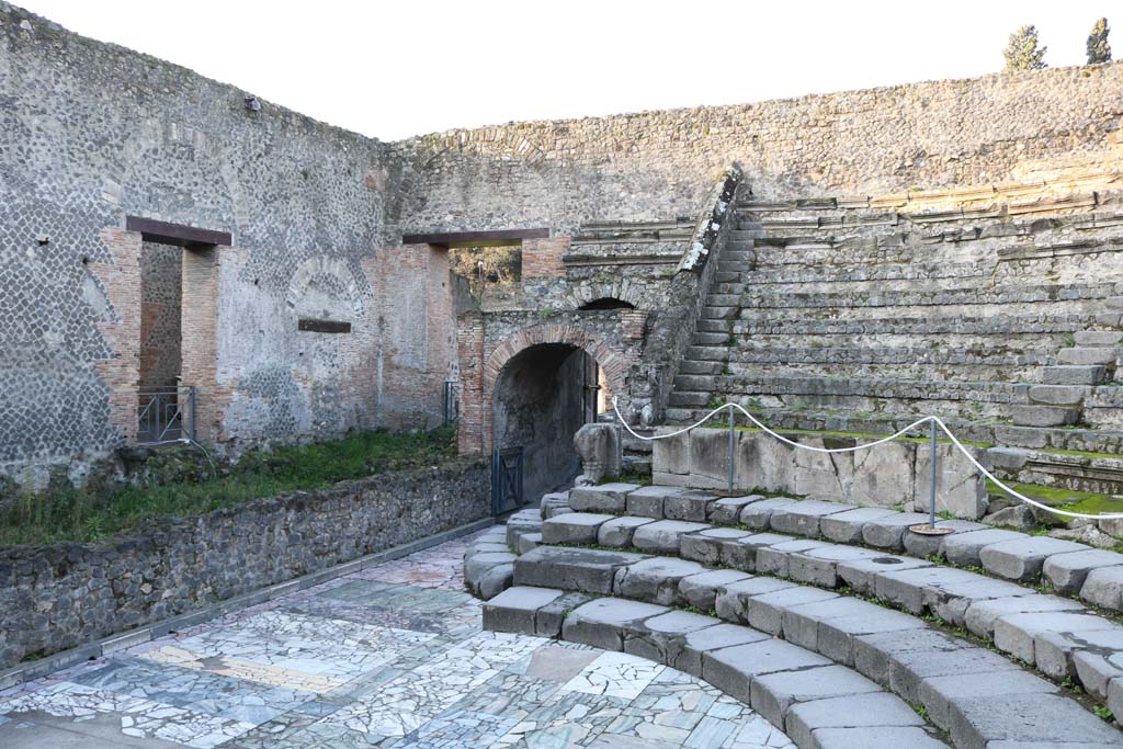 VIII.7.19 Pompeii. December 2018.
Looking south-west towards west end of stage, doorway into corridor at VIII.7.17, and entrance/exit at west end of Theatre.
Photo courtesy of Aude Durand.