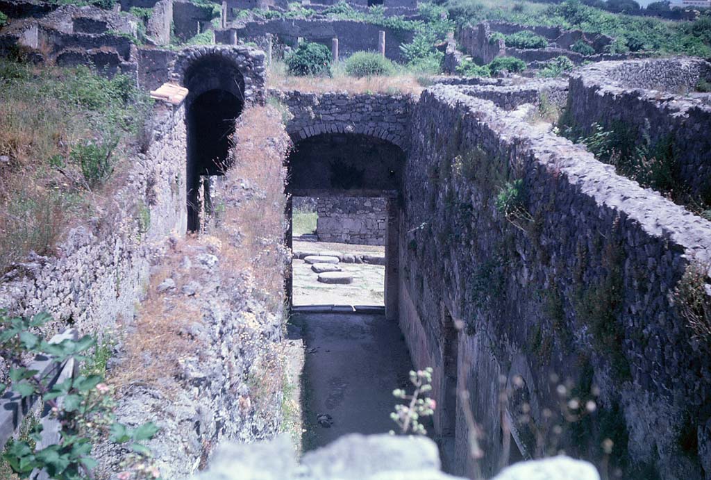 VIII.7.21 (on left) and VIII.7.20 (centre). Pompeii. June 1962.
Looking east from entrance corridors towards Reg. 1, insula 3. Photo courtesy of Rick Bauer.