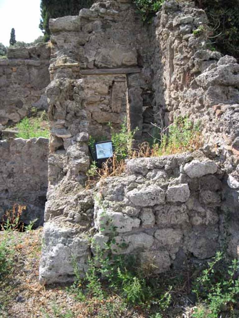 VIII.7.24 Pompeii. September 2010. North-west corner of northern garden portico looking into VIII.7.26. This shows the small room or cupboard on the east side of the triclinium of VIII.7.26. Photo courtesy of Drew Baker.