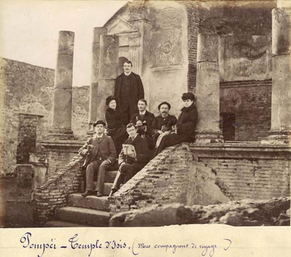 VIII.7.28 Pompeii. Old undated photograph, possibly c.1875 to early 1880s. Photo courtesy of Rick Bauer.
The man in front is holding a book, a copy of the Scafati Guide to Pompeii.
Looking at the higher resolution original photo, the cover of the booklet has an image of the first cast that Fiorelli made in 1863.
It also has a curved top line of type above the word Pompei and has no binding on the spine.
These would date the booklet to the original editions which first came out in 1875.
Based on a comparison with copies of the Scafati guide which Rick has in his private collection, the cover in the photo matches the first edition of the guide book.
As such, he estimates the photo was taken sometime from 1875 to early 1880s.