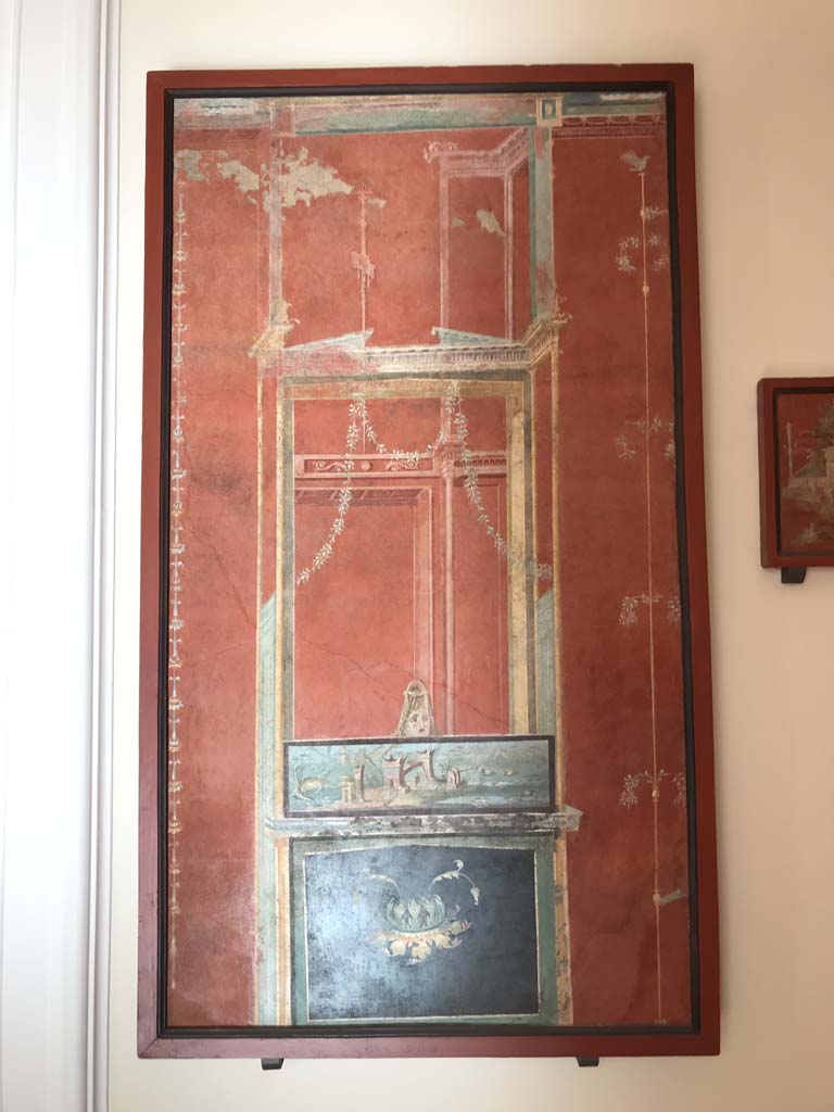 VIII.7.28 Pompeii. April 2019. Ultimate panel on the right of the east wall.
Architectural scene with Nilotic painting surmounted by a mask.
Now in Naples Archaeological Museum. Inventory number 8539. Photo courtesy of Rick Bauer.