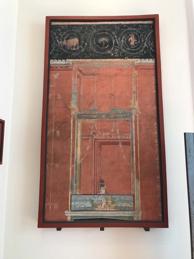 VIII.7.28 Pompeii. April 2019. From the left of the east wall of the portico.
Architectural scene with Nilotic scene surmounted by a female theatrical mask and a frieze of scrolls.
Now in Naples Archaeological Museum. Inventory number 8607.
Photo courtesy of Rick Bauer.