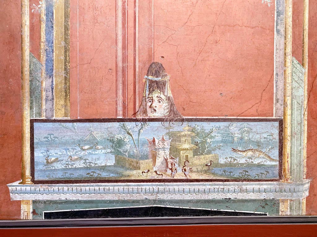 VIII.7.28 Pompeii. December 2019.
From the left of the east wall of the portico. Detail of Nilotic scene with two pigmies and surmounted by a female theatrical mask.
Now in Naples Archaeological Museum. Inventory number 8607.
Photo courtesy of Giuseppe Ciaramella.